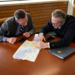 Office of the Governor
Yukon Premier Currie Dixon and Alaska Gov. Mike Dunleavy examine a map during a meeting at the Arctic Winter Games in Whitehorse in March.