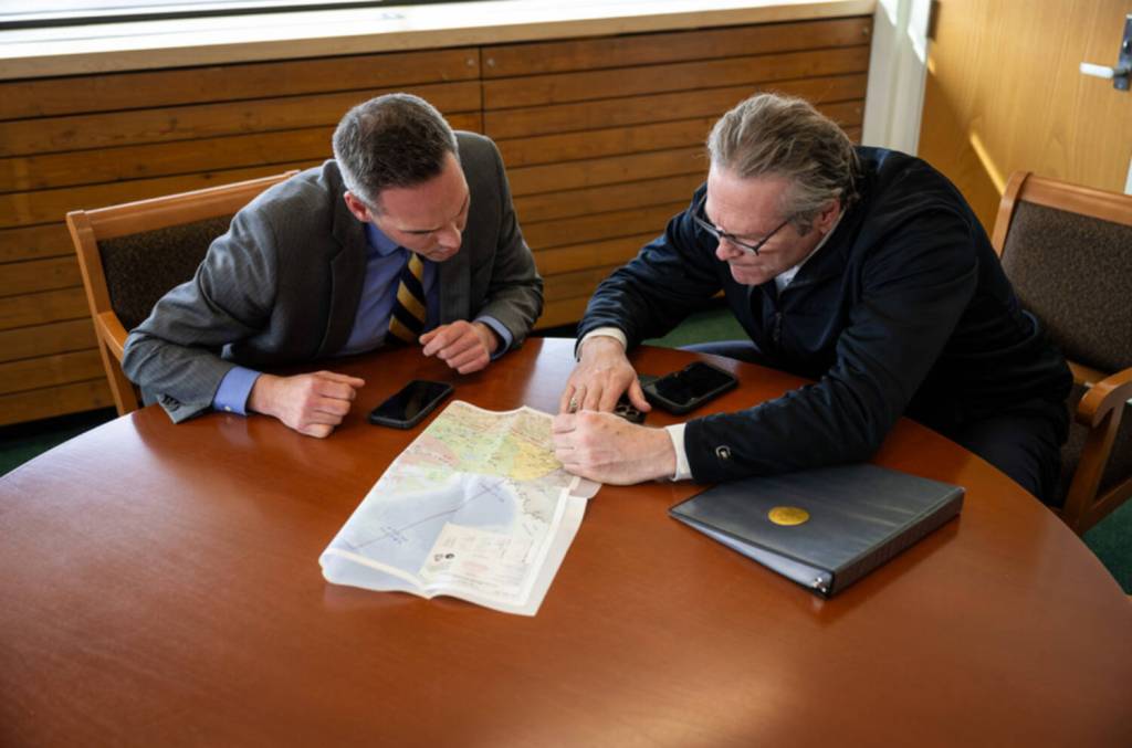 Office of the Governor
Yukon Premier Currie Dixon and Alaska Gov. Mike Dunleavy examine a map during a meeting at the Arctic Winter Games in Whitehorse in March.